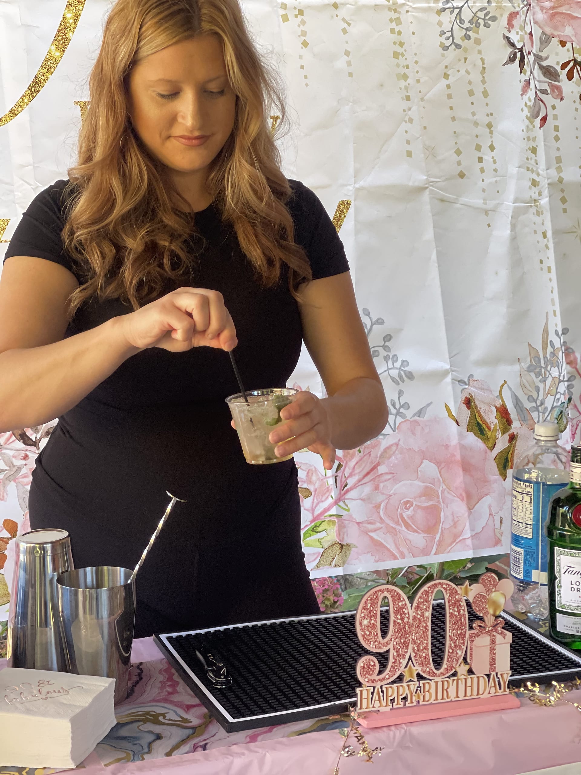 A Tow And Toast bartender stirring a cocktail behind the bar